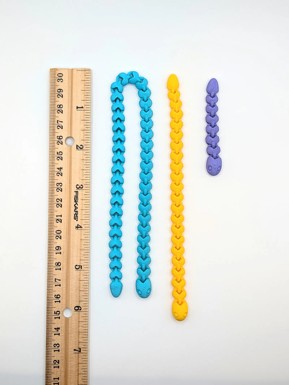 Cute Snakey next to a ruler for size (designer photo)